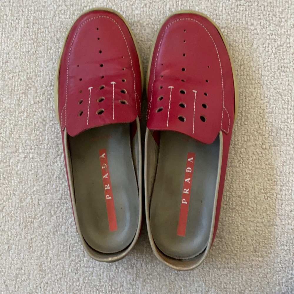 Prada red slides.